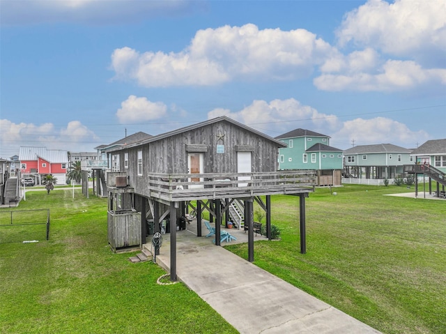 23001 Fresca St, Galveston, TX 77554 - surrounding community with stairs, driveway, a lawn, a carport, and a residential view