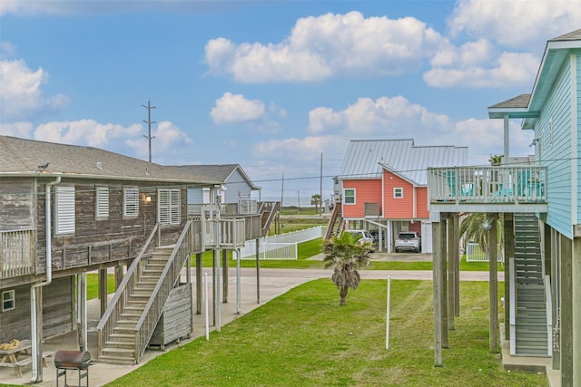 23001 Fresca St, Galveston, TX 77554 - view of play area featuring stairs, a yard, and a wooden deck