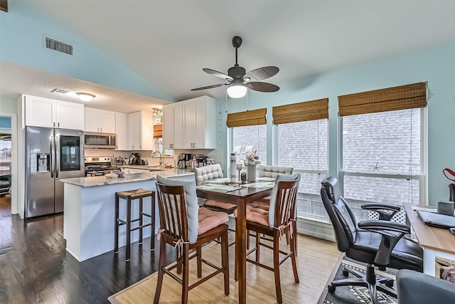 23001 Fresca St, Galveston, TX 77554 - dining area with wood finished floors, ceiling fan, and lofted ceiling