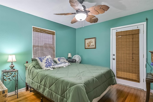 23001 Fresca St, Galveston, TX 77554 - bedroom with wood-type flooring, a ceiling fan, and baseboards