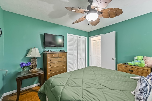 23001 Fresca St, Galveston, TX 77554 - bedroom featuring wood finished floors, baseboards, ceiling fan, and a closet