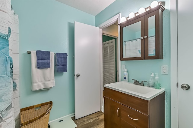 23001 Fresca St, Galveston, TX 77554 - full bathroom featuring wood finished floors, vanity, and a closet