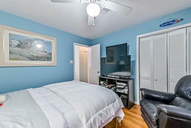 23001 Fresca St, Galveston, TX 77554 - bedroom featuring wood finished floors, a closet, and a ceiling fan
