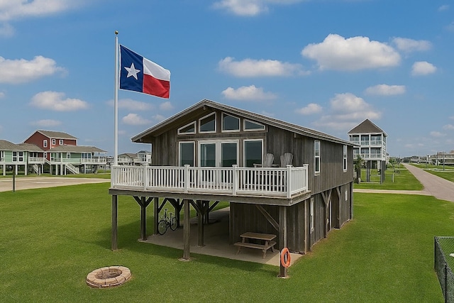 23001 Fresca St, Galveston, TX 77554 - back of house with a lawn, a carport, and a deck