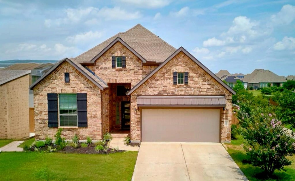 23302 Ivory Sedge Trl, Katy, TX 77493 - view of front facade with brick siding, concrete driveway, and a front lawn