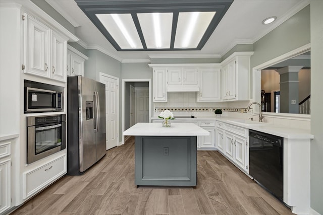 kitchen featuring light countertops, stainless steel appliances, white cabinets, and a sink