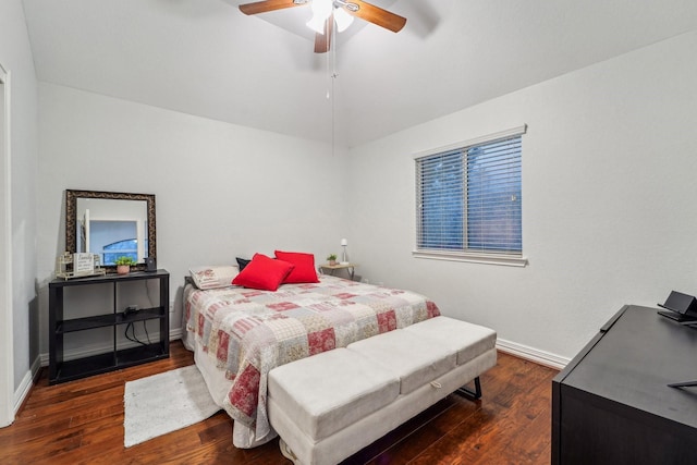 bedroom with wood finished floors, vaulted ceiling, baseboards, and ceiling fan