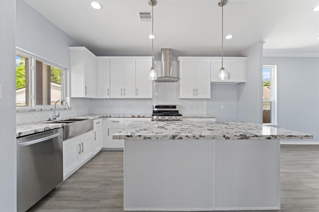 1215 E 34th St Unit A, Houston, TX 77022 - kitchen with stainless steel appliances, wall chimney exhaust hood, plenty of natural light, tasteful backsplash, and recessed lighting