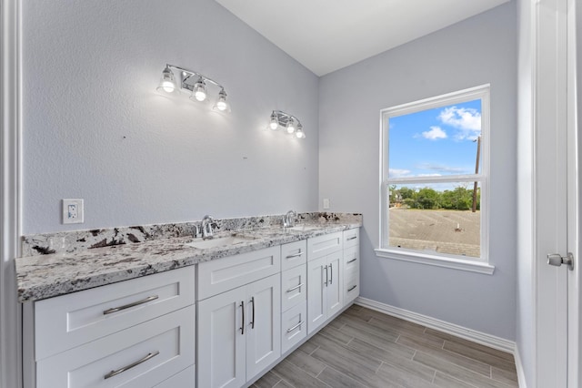 1215 E 34th St Unit A, Houston, TX 77022 - bathroom featuring double vanity and wood finished floors
