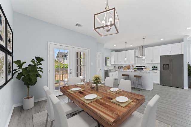 1215 E 34th St Unit A, Houston, TX 77022 - dining space featuring a chandelier, light wood finished floors, recessed lighting, and french doors