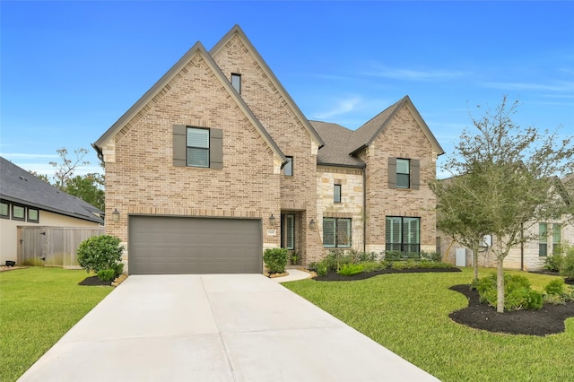 view of front of home featuring fence, a front lawn, driveway, brick siding, and a garage