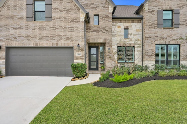 view of front facade featuring brick siding, driveway, a front yard, and roof with shingles