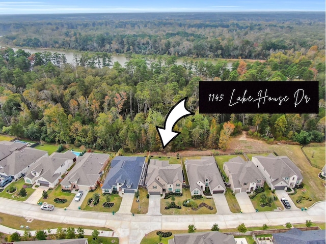 bird's eye view with a view of trees, a residential view, and a water view