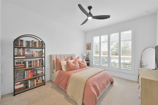 bedroom featuring ceiling fan and light carpet