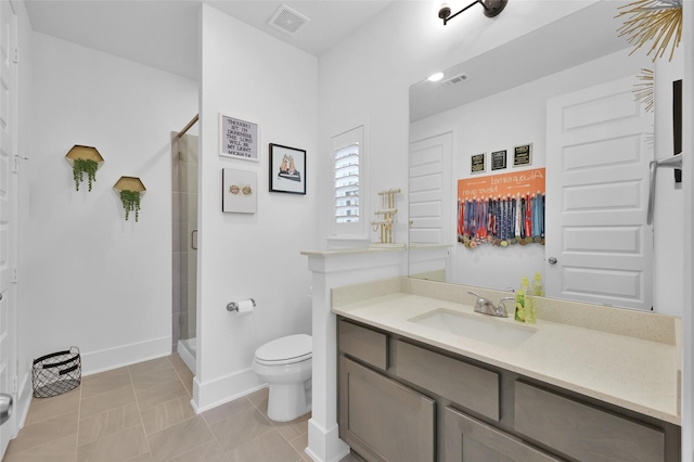 bathroom featuring a stall shower, toilet, baseboards, visible vents, and vanity
