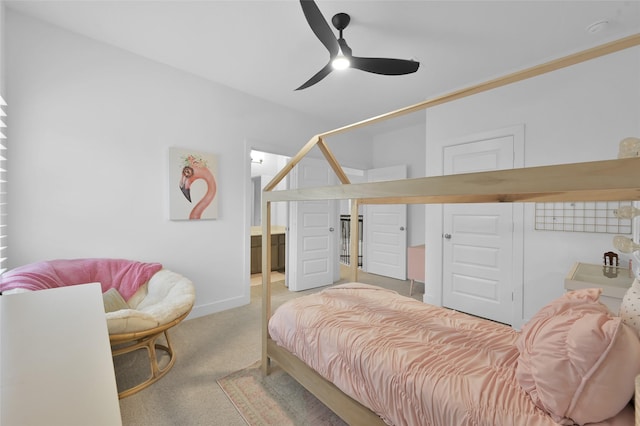 bedroom with a ceiling fan, baseboards, and carpet