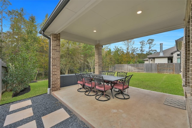 view of patio featuring a fenced backyard and outdoor dining area