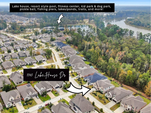 aerial view with a water view, a residential view, and a wooded view