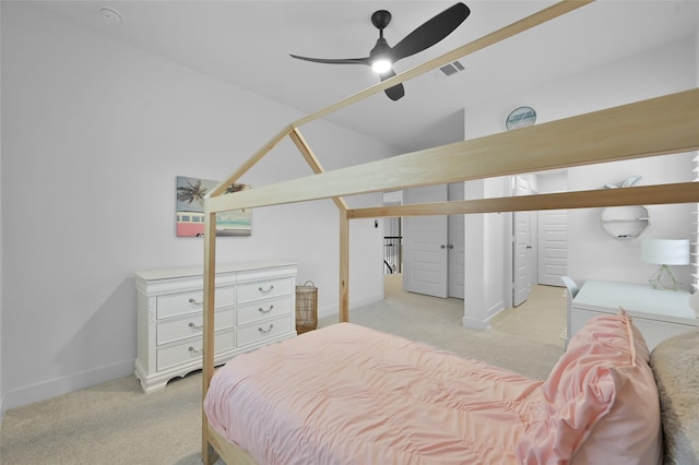 bedroom with lofted ceiling, light carpet, baseboards, and visible vents