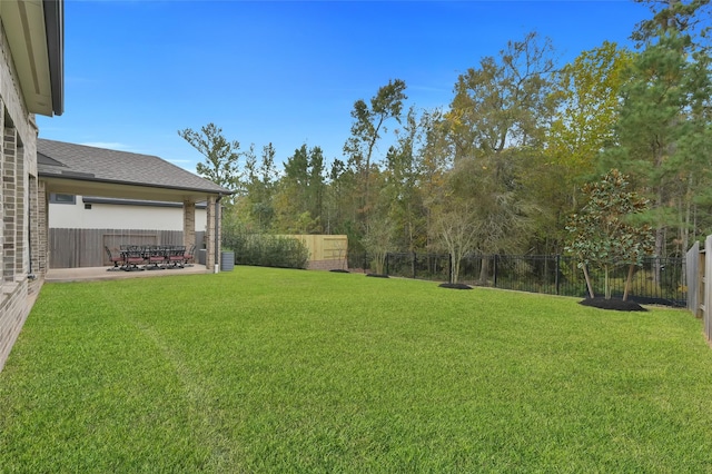 view of yard with a fenced backyard and a patio