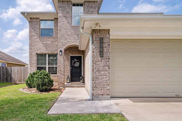 1962 Briar Grove Dr, Conroe, TX 77301 - entrance to property with brick siding, concrete driveway, and an attached garage