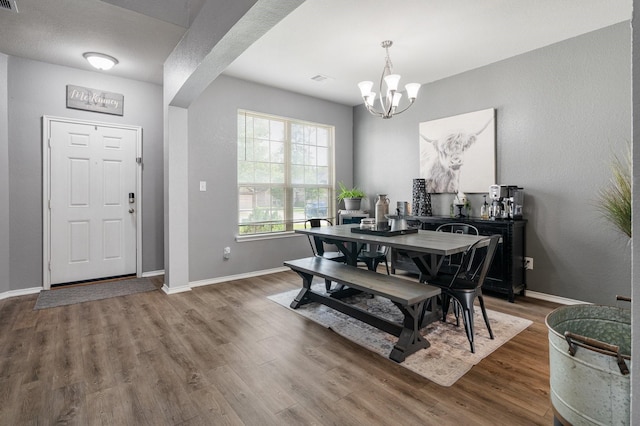 1962 Briar Grove Dr, Conroe, TX 77301 - dining room featuring a chandelier, wood finished floors, baseboards, and an office area