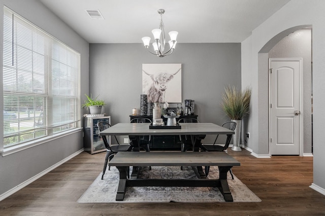 1962 Briar Grove Dr, Conroe, TX 77301 - dining space with arched walkways, a chandelier, wood finished floors, and baseboards