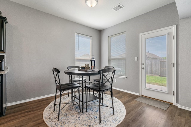 1962 Briar Grove Dr, Conroe, TX 77301 - dining area featuring dark wood finished floors, plenty of natural light, baseboards, and a textured wall