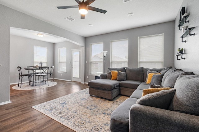1962 Briar Grove Dr, Conroe, TX 77301 - living room featuring arched walkways, a ceiling fan, wood finished floors, and baseboards