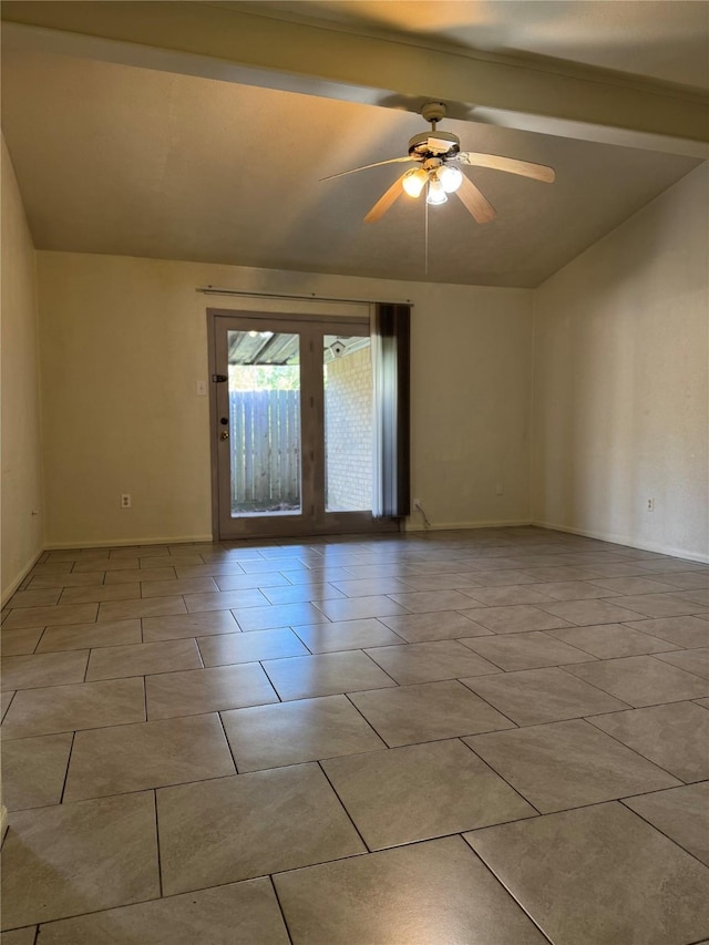 spare room with light tile patterned floors, vaulted ceiling, baseboards, and ceiling fan