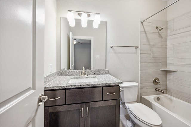 full bathroom featuring vanity, bathing tub / shower combination, and toilet