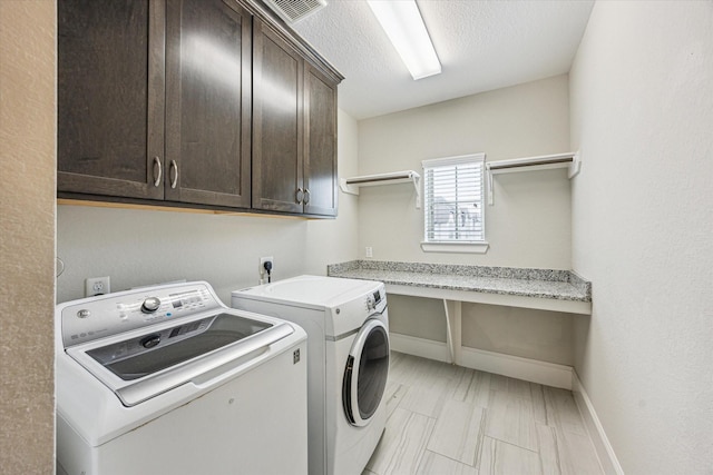 washroom with separate washer and dryer, cabinet space, baseboards, and visible vents