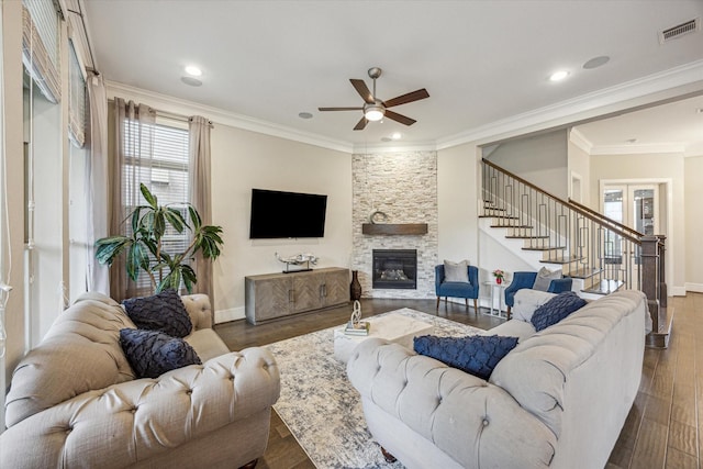 living room featuring a ceiling fan, visible vents, a healthy amount of sunlight, and a fireplace