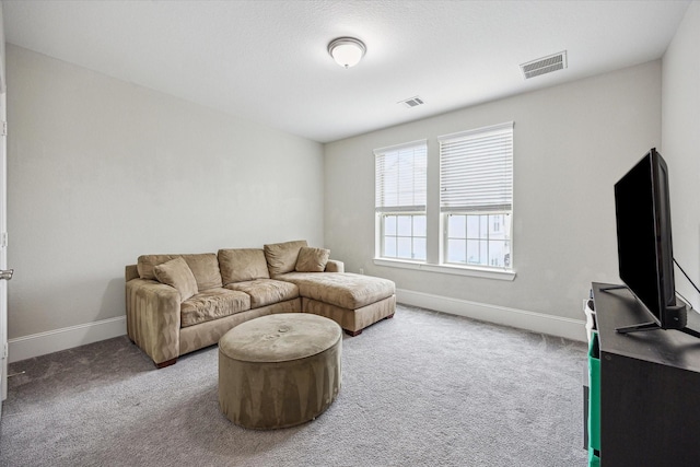 carpeted living room with baseboards and visible vents