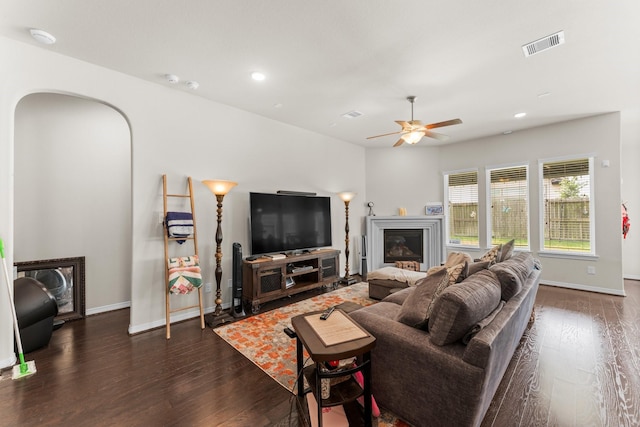 11134 Honeysuckle Haven Dr, Cypress, TX 77433 - living area featuring a ceiling fan, wood finished floors, arched walkways, baseboards, and visible vents