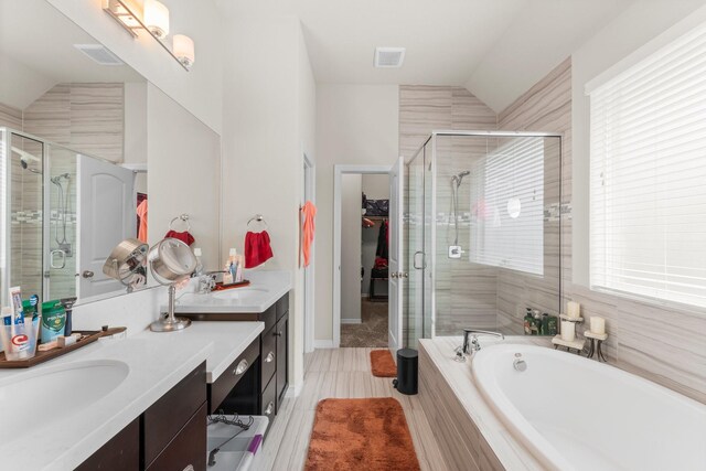 11134 Honeysuckle Haven Dr, Cypress, TX 77433 - full bathroom featuring vaulted ceiling, a sink, double vanity, and a stall shower