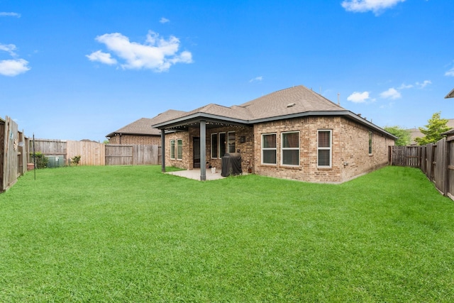 11134 Honeysuckle Haven Dr, Cypress, TX 77433 - rear view of house with brick siding, a yard, a fenced backyard, and a patio