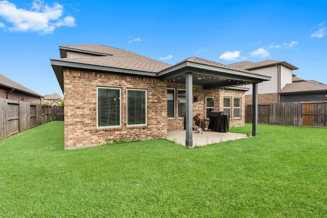 11134 Honeysuckle Haven Dr, Cypress, TX 77433 - rear view of property featuring a fenced backyard, brick siding, a yard, and a patio