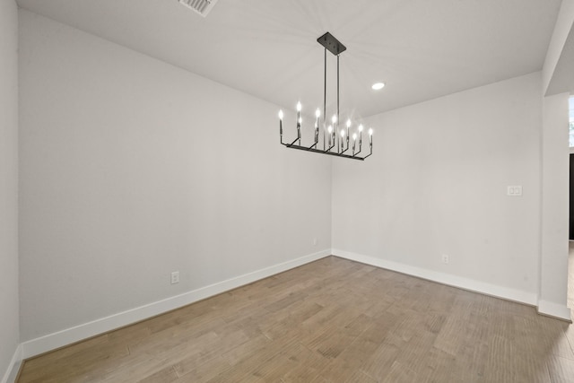 21806 Gateway Arch Dr, Porter, TX 77365 - spare room with a chandelier, recessed lighting, and wood finished floors