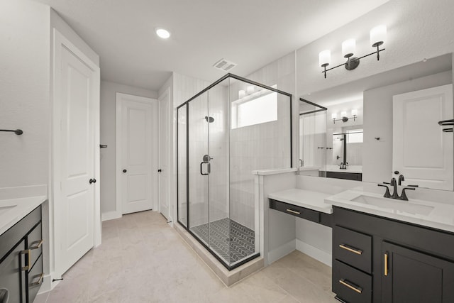 21806 Gateway Arch Dr, Porter, TX 77365 - full bath featuring two vanities, a shower stall, tile patterned floors, and recessed lighting