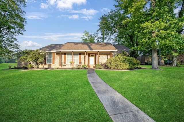 single story home featuring brick siding, a porch, and a front yard