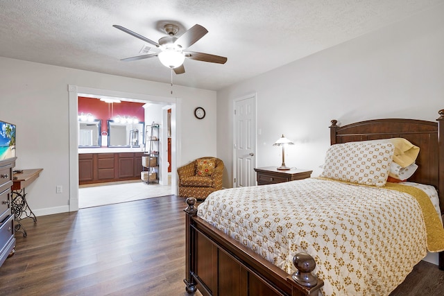 bedroom with ensuite bathroom, wood finished floors, and a textured ceiling