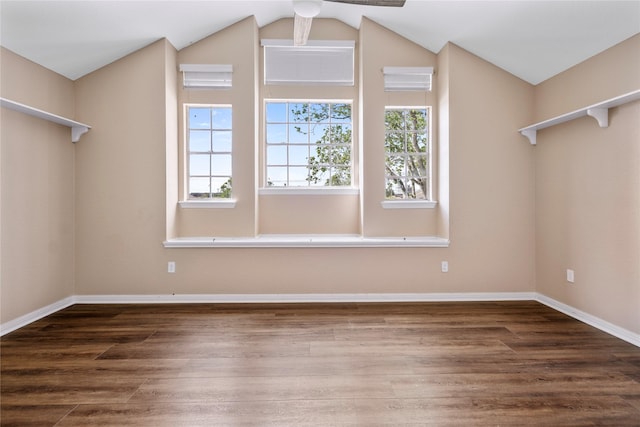 additional living space with vaulted ceiling, wood finished floors, and baseboards