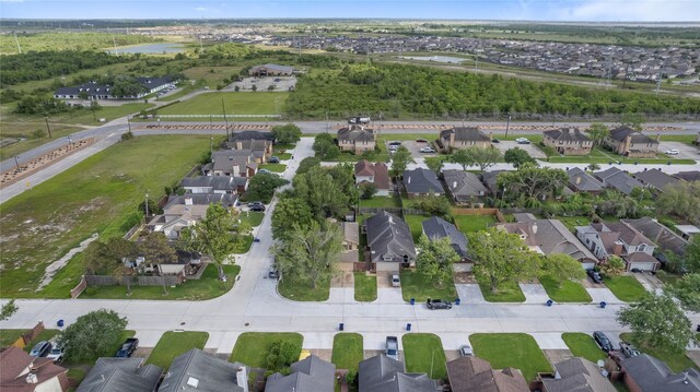 drone / aerial view featuring a residential view and a water view