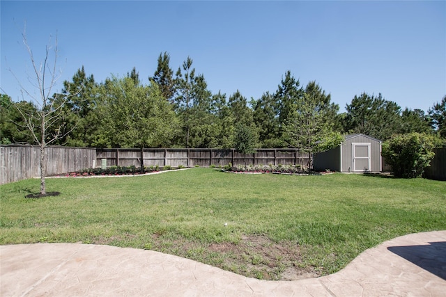 view of yard with a fenced backyard, an outbuilding, and a shed
