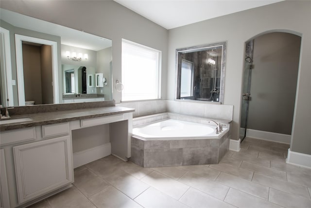 full bath featuring tile patterned floors, toilet, a shower stall, a garden tub, and vanity