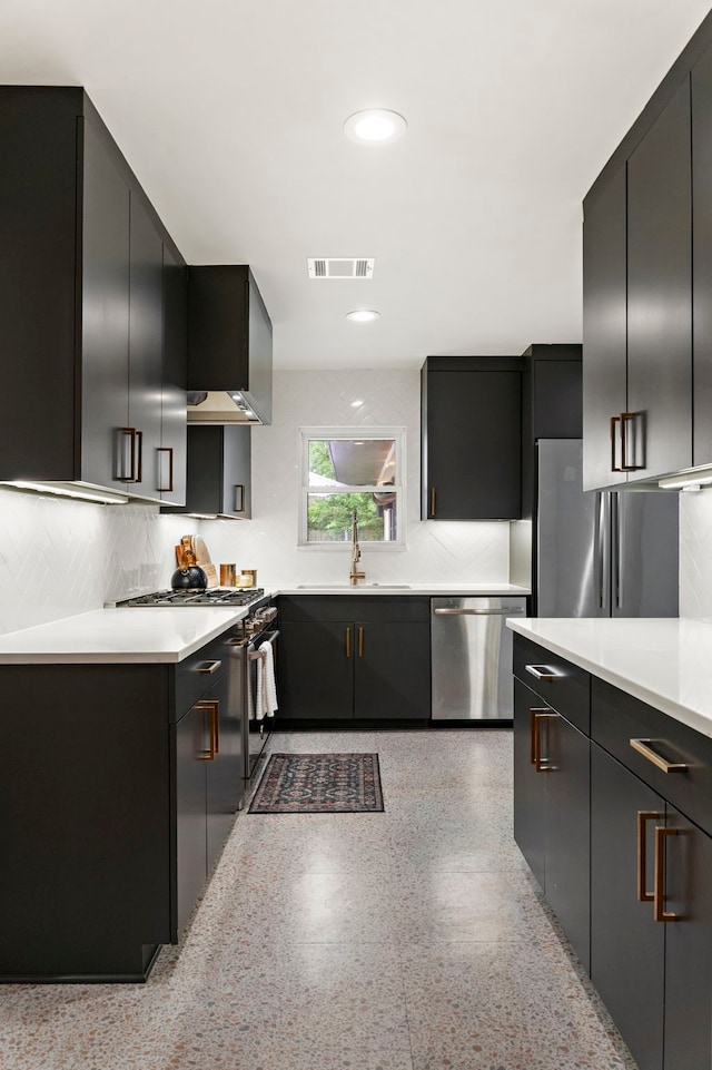 5301 Nina Lee Ln, Houston, TX 77092 - kitchen with appliances with stainless steel finishes, a sink, dark cabinets, light countertops, and backsplash