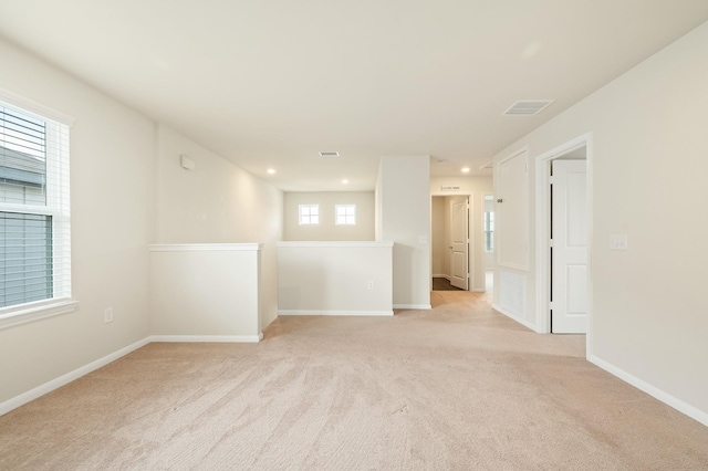 empty room with light carpet, baseboards, visible vents, and recessed lighting