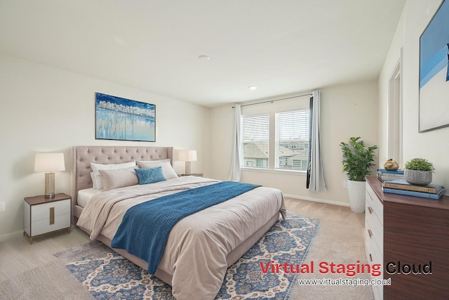 bedroom with light carpet and baseboards