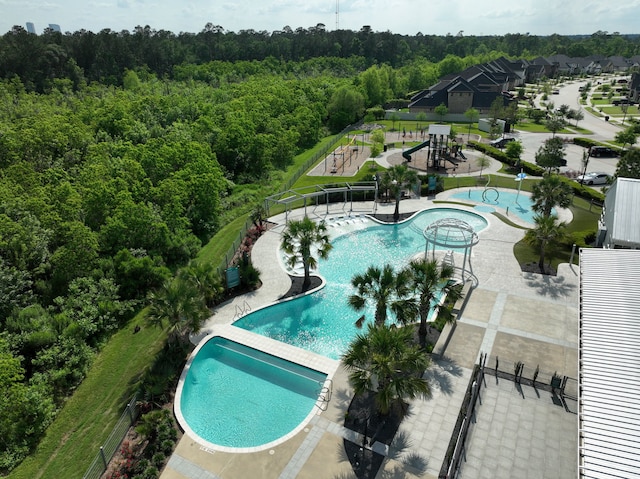 10021 Preserve Way, Conroe, TX 77385 - community pool with a forest view, a community hot tub, and a patio